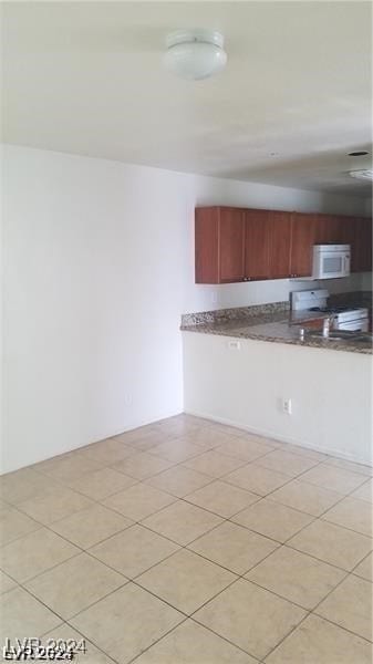 kitchen featuring white appliances and light tile patterned floors