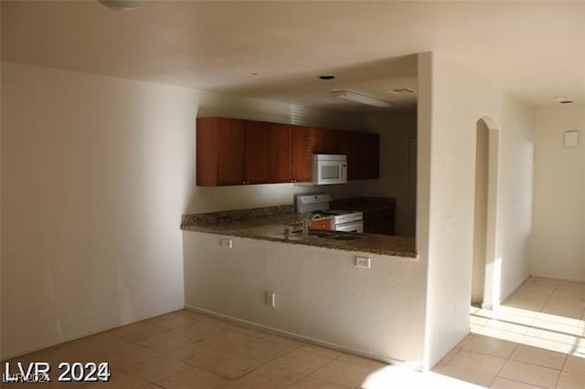 kitchen with light tile patterned floors and white appliances