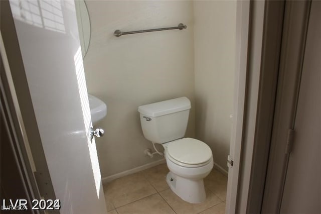 bathroom featuring toilet and tile patterned floors