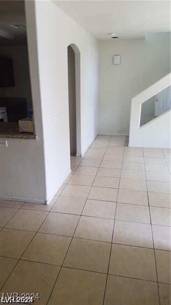 hall with light tile patterned floors