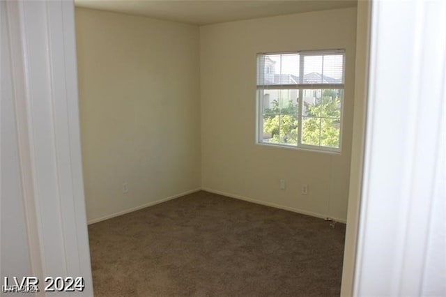 empty room with dark colored carpet