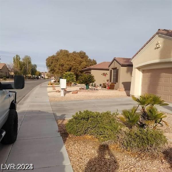 1652 Black Fox Canyon Rd, Henderson, NV 89052 - view of yard with concrete driveway and an attached garage