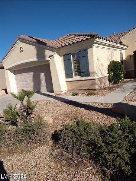 1652 Black Fox Canyon Rd, Henderson, NV 89052 - mediterranean / spanish-style home with a tiled roof, an attached garage, concrete driveway, and stucco siding