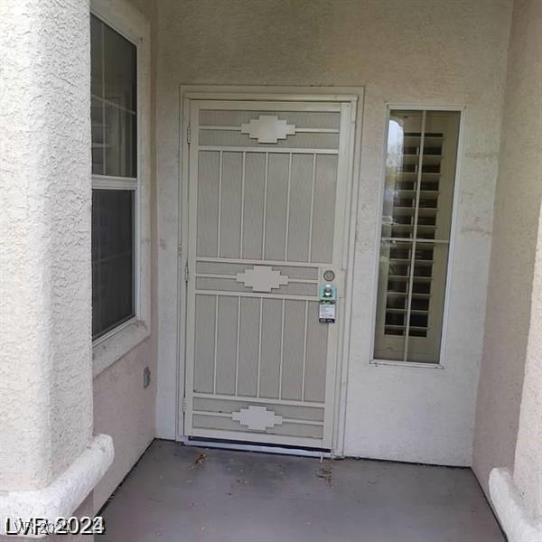 1652 Black Fox Canyon Rd, Henderson, NV 89052 - doorway to property featuring stucco siding