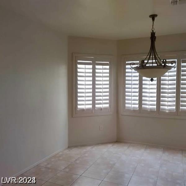 1652 Black Fox Canyon Rd, Henderson, NV 89052 - unfurnished dining area featuring healthy amount of natural light and light tile patterned floors