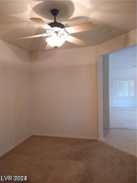 unfurnished room with ceiling fan and carpet