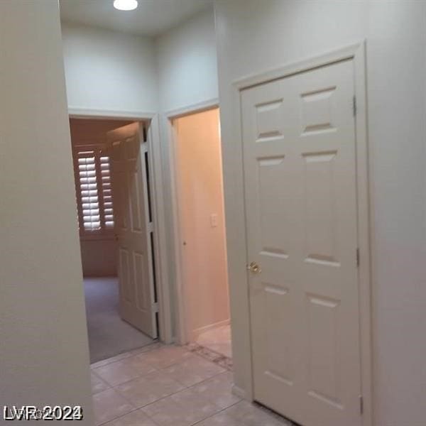 hallway featuring light tile patterned floors