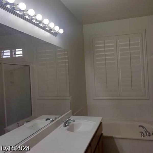 1652 Black Fox Canyon Rd, Henderson, NV 89052 - bathroom featuring vanity, a bath, and a shower