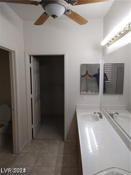 1652 Black Fox Canyon Rd, Henderson, NV 89052 - full bath featuring double vanity, tile patterned flooring, toilet, and ceiling fan