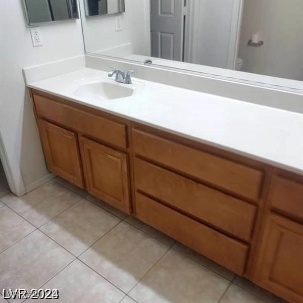 bathroom with vanity, toilet, and tile patterned floors