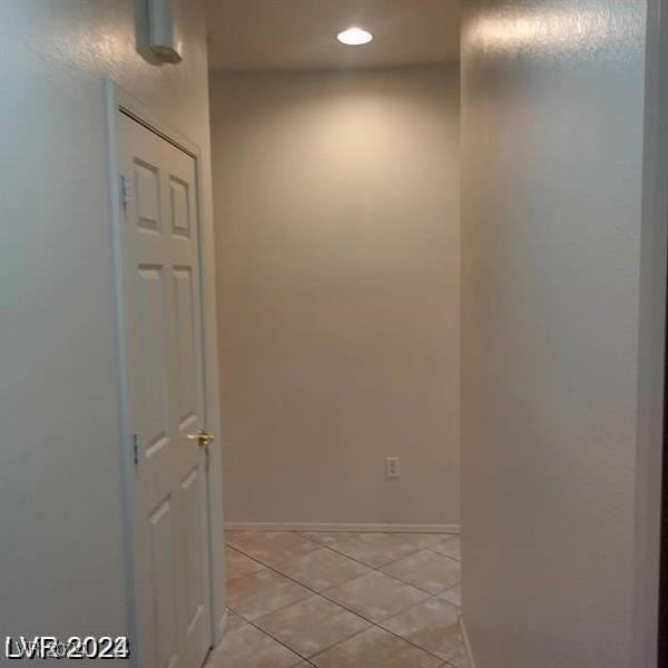 1652 Black Fox Canyon Rd, Henderson, NV 89052 - hallway with light tile patterned floors, recessed lighting, and baseboards