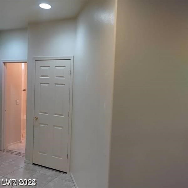 hallway with light tile patterned floors