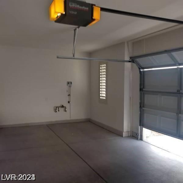 1652 Black Fox Canyon Rd, Henderson, NV 89052 - garage with a garage door opener and baseboards