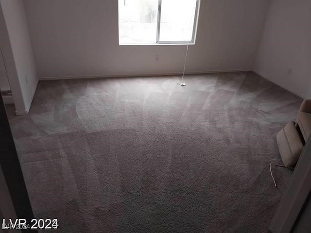 empty room with dark carpet