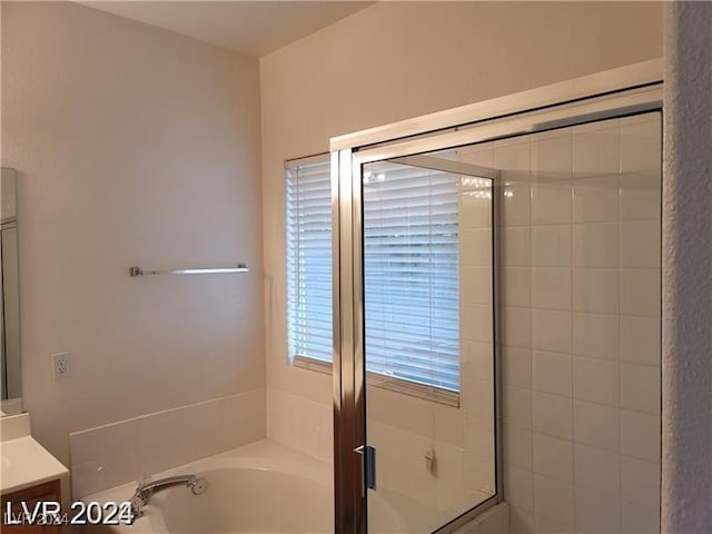 bathroom with vanity and independent shower and bath