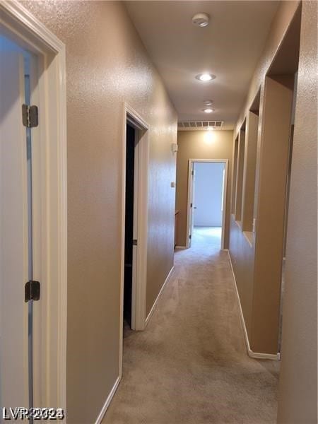 corridor featuring light carpet