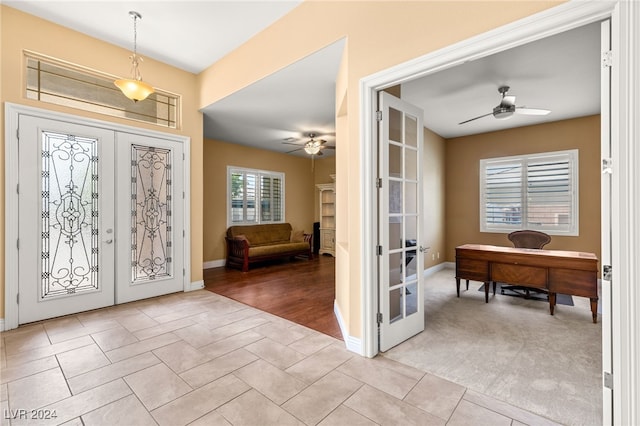 foyer entrance with french doors, light hardwood / wood-style flooring, and ceiling fan