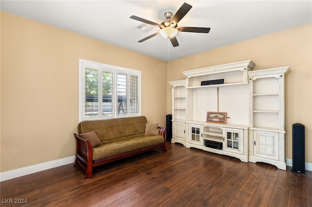 living area with dark wood-type flooring and ceiling fan