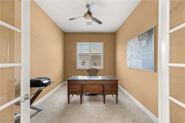 carpeted office space with ceiling fan