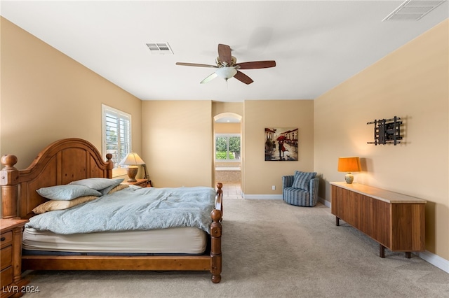 bedroom featuring light colored carpet and ceiling fan