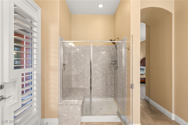 bathroom featuring walk in shower, radiator, and tile patterned floors