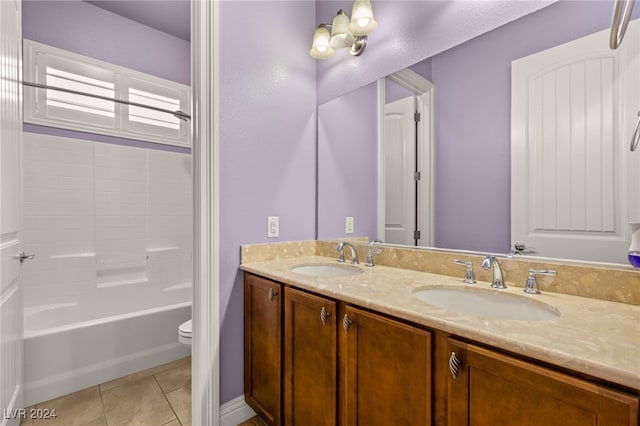 full bathroom featuring toilet, vanity, tile patterned flooring, and  shower combination