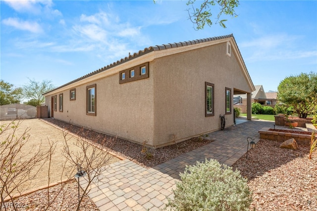 view of side of property featuring a patio