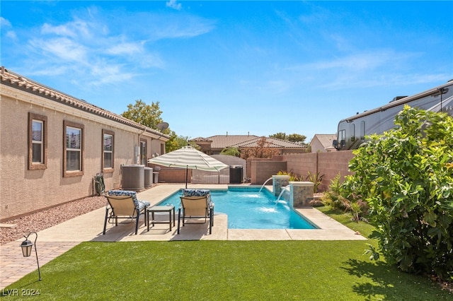 view of swimming pool with a patio area, a lawn, and pool water feature