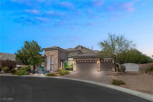 mediterranean / spanish-style home with a garage