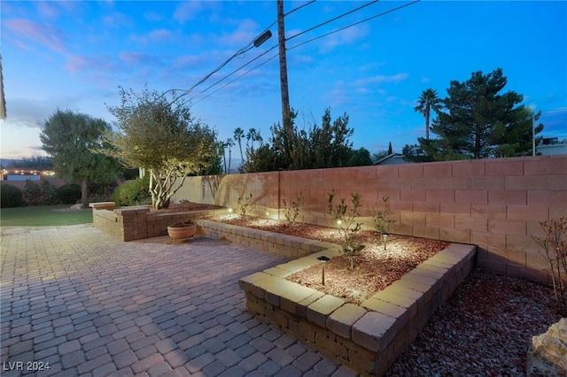 view of patio terrace at dusk