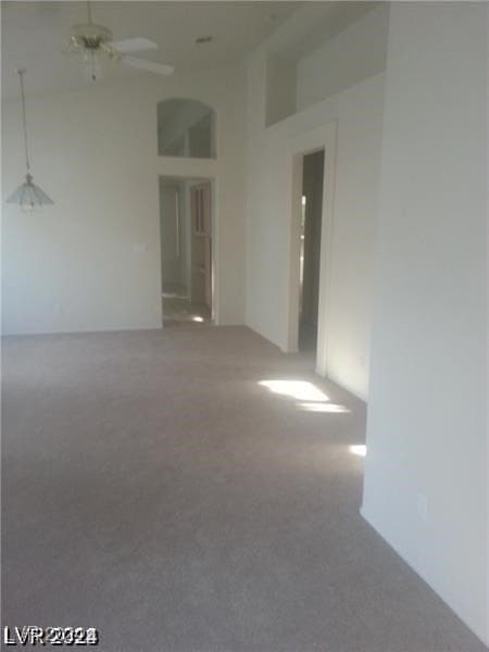 unfurnished room with ceiling fan and carpet flooring