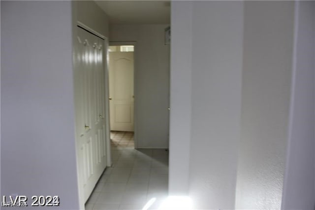 hall featuring light tile patterned floors