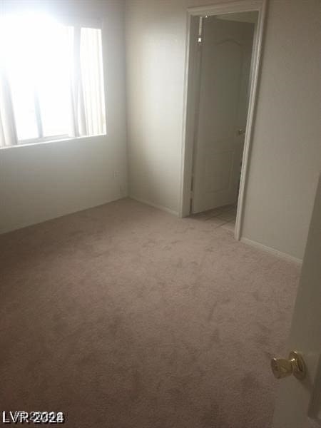 unfurnished room with light colored carpet