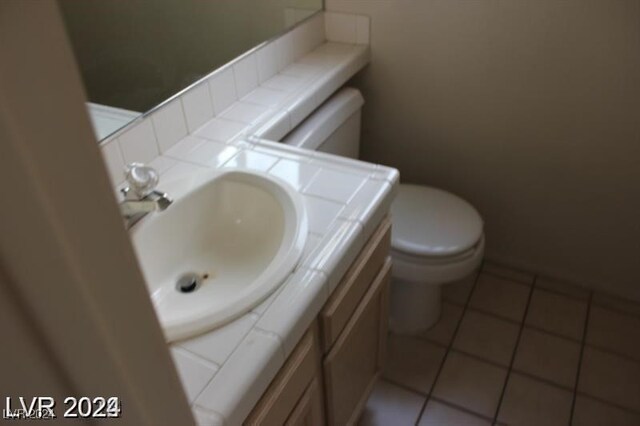 bathroom featuring vanity, toilet, and tile patterned floors