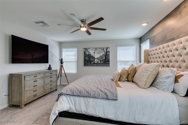 bedroom featuring light colored carpet and ceiling fan