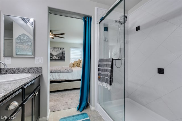 bathroom featuring a shower with door, vanity, and ceiling fan