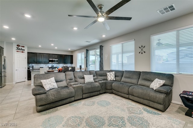 living room with ceiling fan and light tile patterned floors