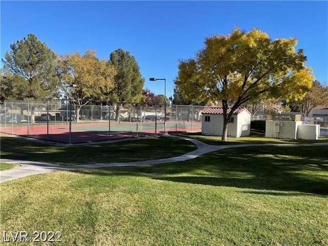 surrounding community featuring a lawn and tennis court