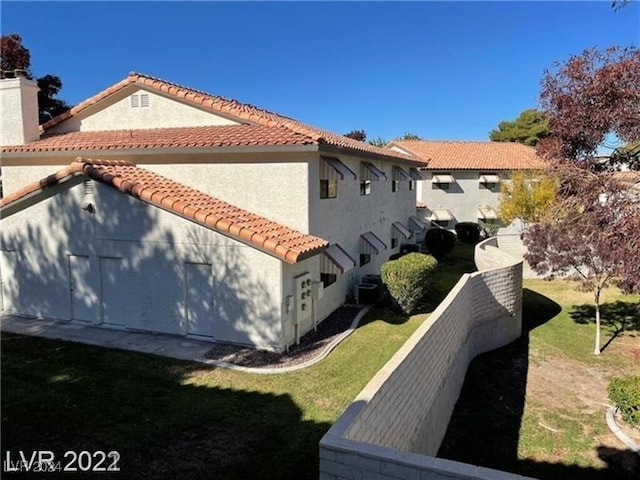 view of side of property with a lawn