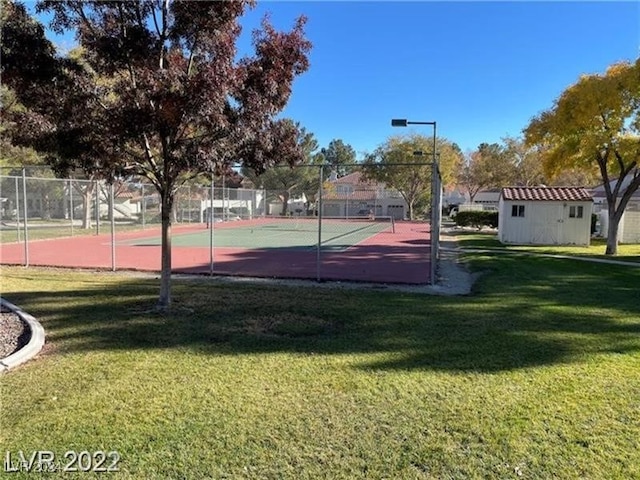 view of sport court featuring a yard