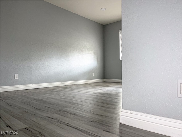 spare room featuring wood-type flooring