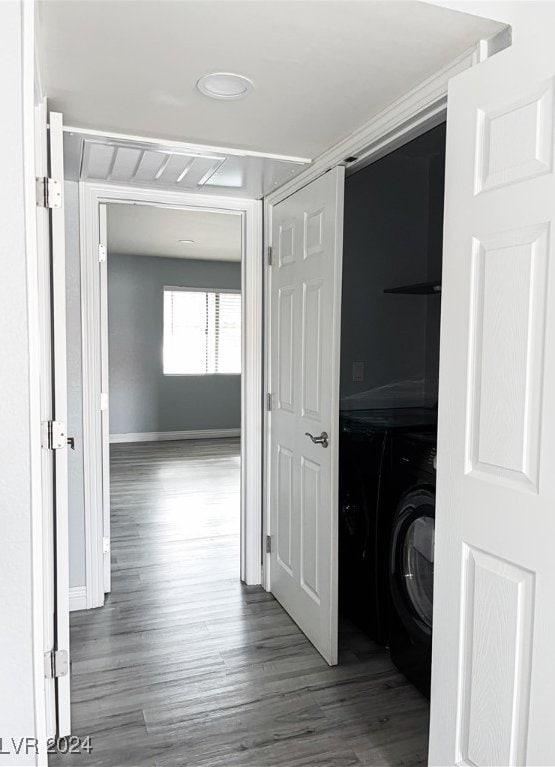 hallway with hardwood / wood-style floors and washer / clothes dryer