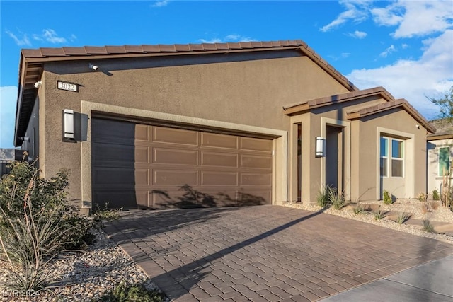 view of front of house featuring a garage and stucco siding
