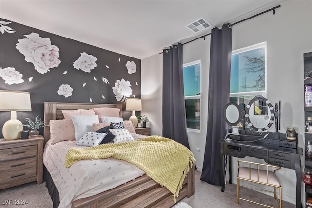 bedroom with visible vents and carpet flooring