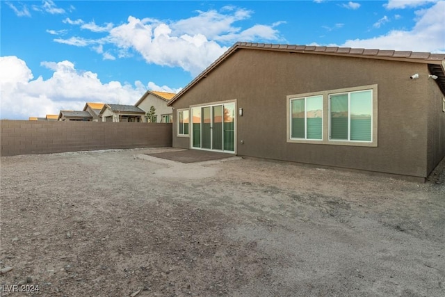 back of house with a patio, a fenced backyard, and stucco siding