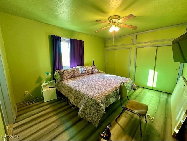 bedroom featuring ceiling fan, wood-type flooring, and a closet