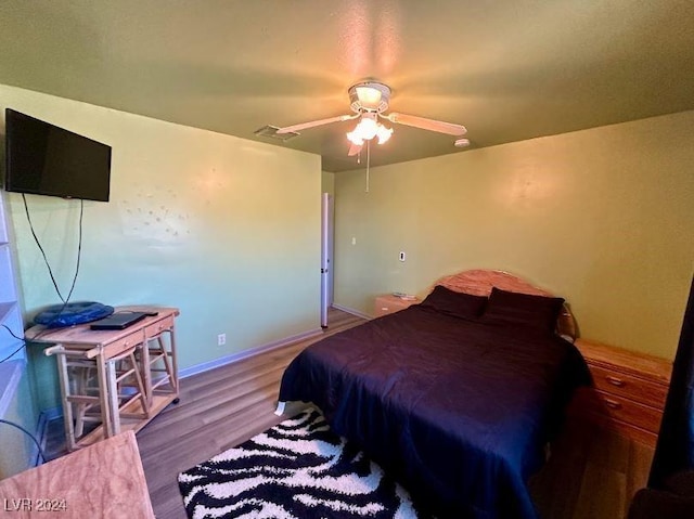 bedroom featuring hardwood / wood-style flooring and ceiling fan