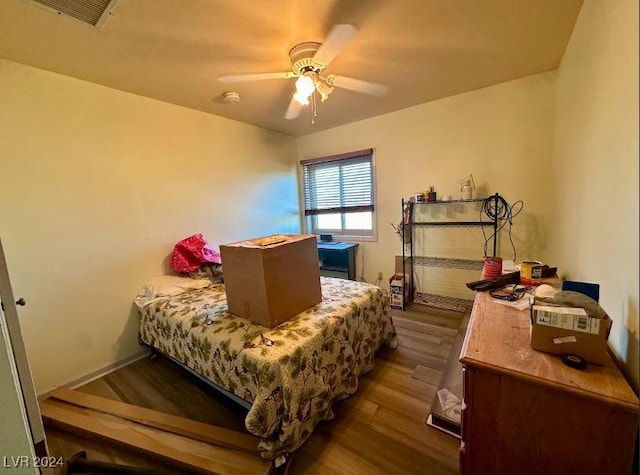 bedroom featuring ceiling fan and dark wood-type flooring