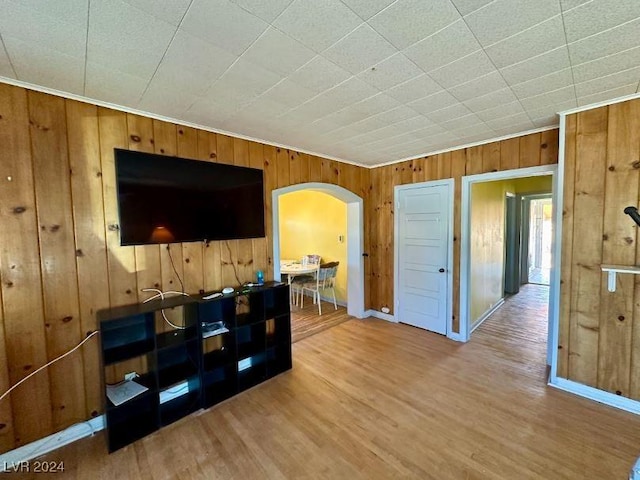 living room featuring hardwood / wood-style floors and wooden walls