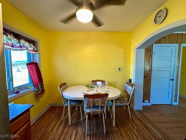 dining room with ceiling fan and dark hardwood / wood-style flooring